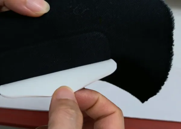 Checking the adhesion strength and quality of the bonded PVC patch.