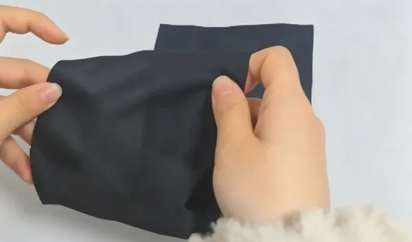 Pre-laminating hot-melt adhesive film with white release paper onto black fabric
