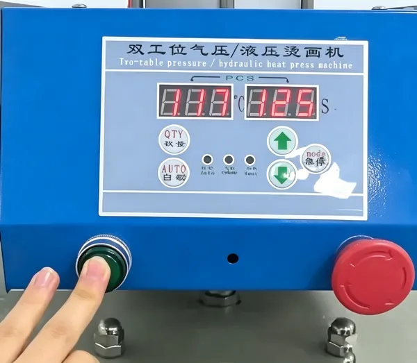 Operating the start button on a pneumatic heat press machine control panel