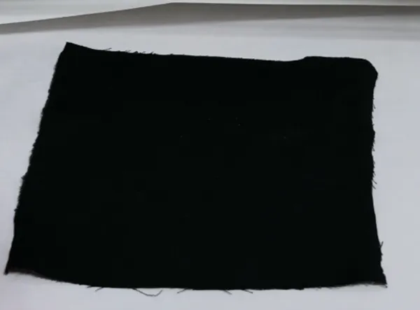 Black Oxford fabric base prepared for hot melt adhesive lamination.