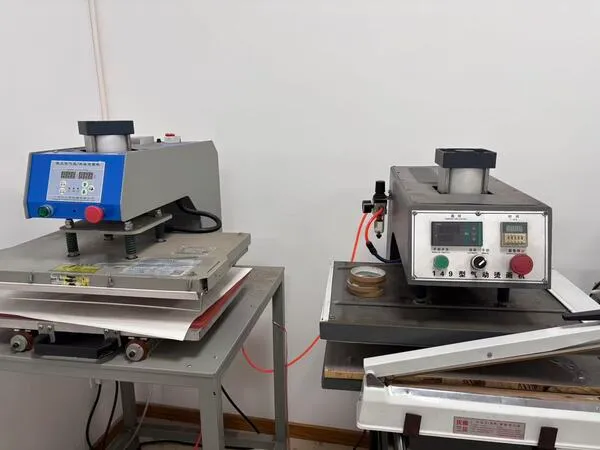 Dual-station pneumatic heat press machines in a factory setting