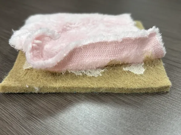 heat activated adhesive film bonding fabric to felt