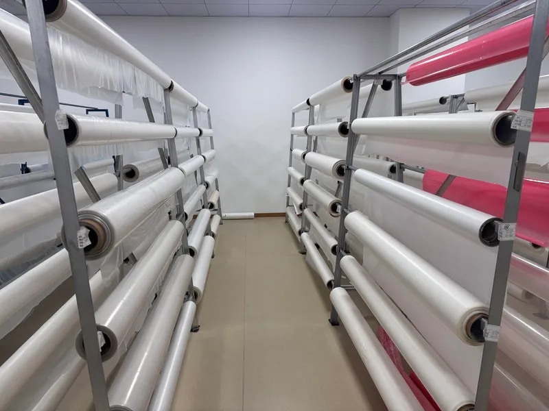 Hot melt adhesive material rolls for industrial lamination